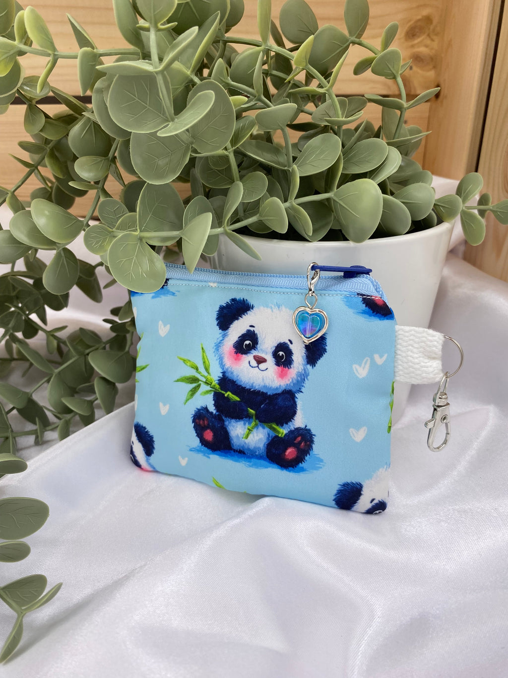 Small pouch with a panda design on a white fabric background
